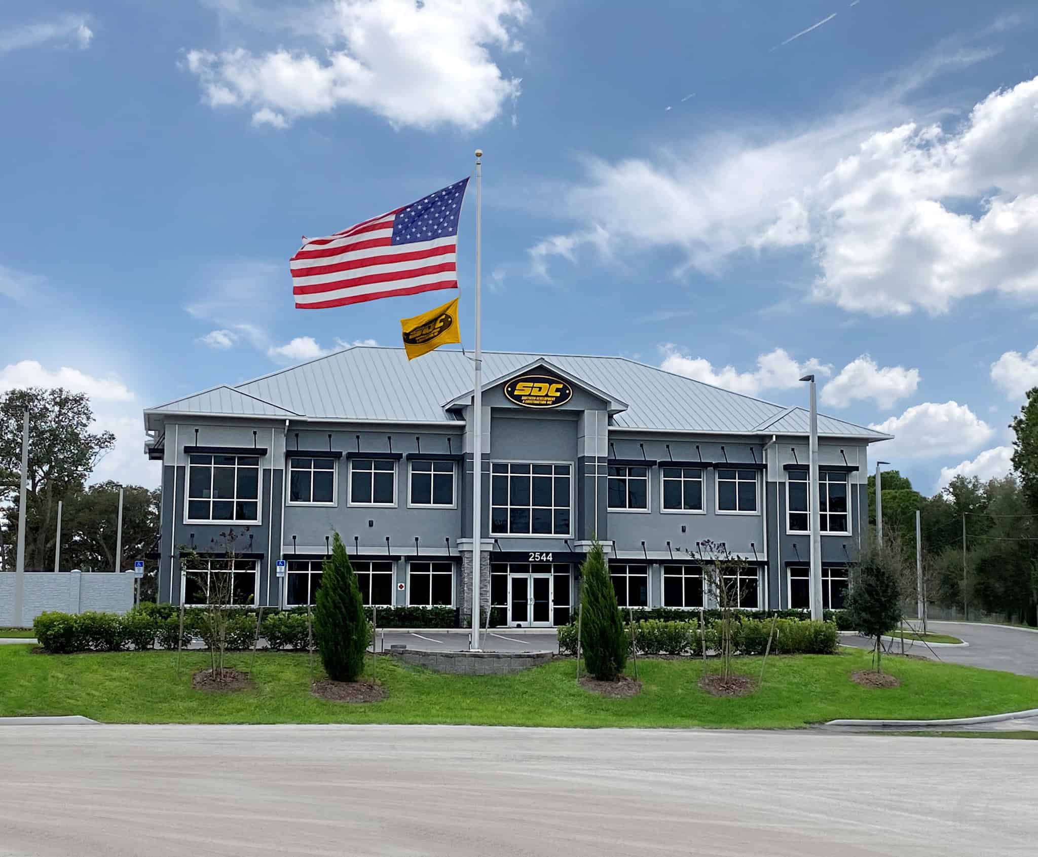 SDC corporate headquarters in Oviedo, Florida with American and SDC flags flying.