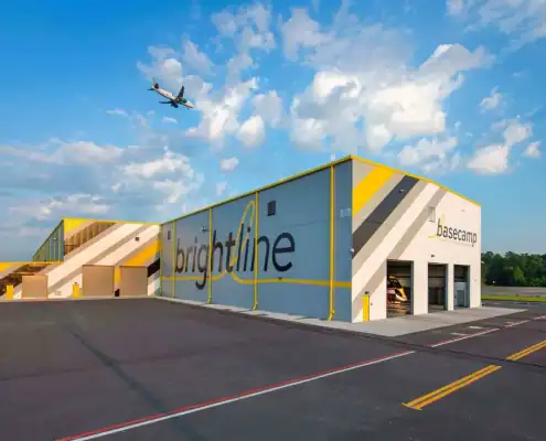 Modern industrial building with Brightline branding at Basecamp site development in Florida, showcasing infrastructure for commercial and logistics projects.