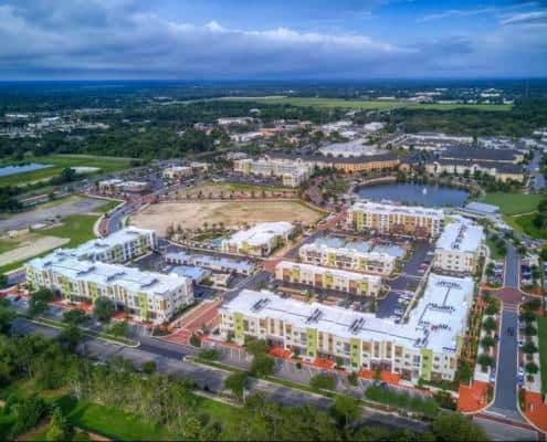 Modern residential community with new construction, landscaping, and water features, showcasing professional site development and urban planning for optimal real estate growth.