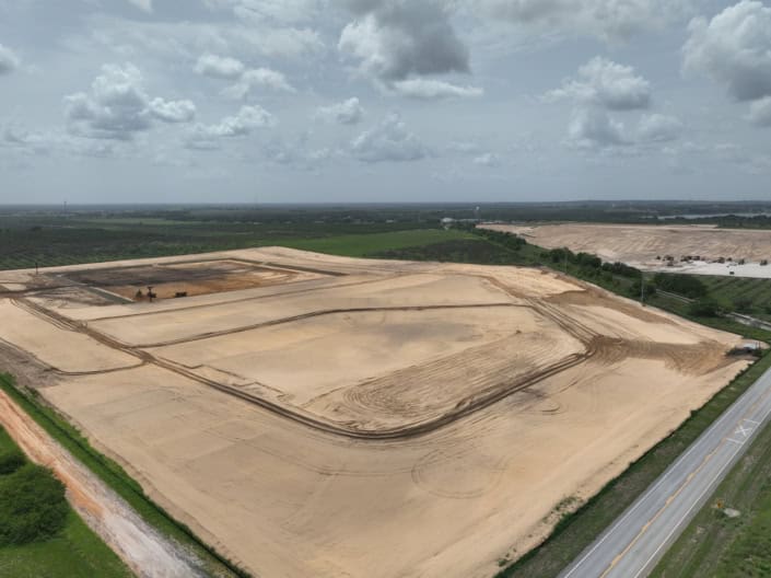Excavation site for commercial development, showcasing site preparation and land grading for future construction projects in Florida.