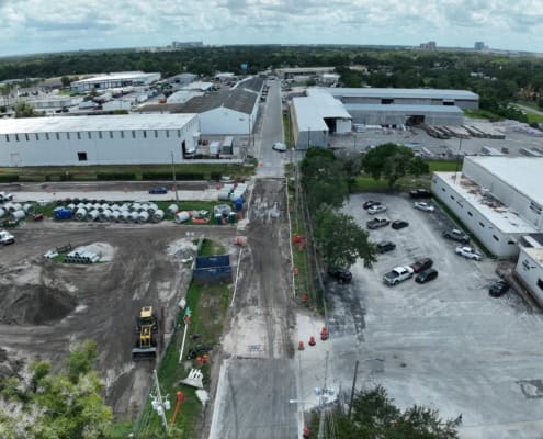 Industrial construction site with ongoing development of warehouse facilities and infrastructure, showcasing site development and commercial building projects.