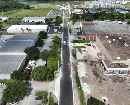 Road construction and site development for commercial building project, enhancing infrastructure and functionality.