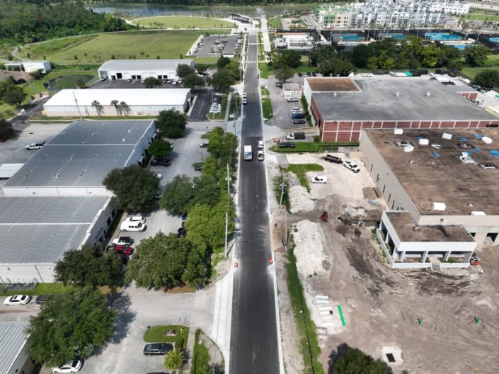 Road construction and site development for commercial building project, enhancing infrastructure and functionality.