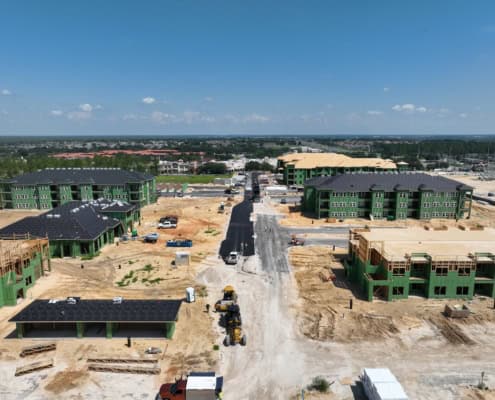 New residential apartment complex under construction in Florida with multi-story buildings, site development, and paved roads for modern living communities.