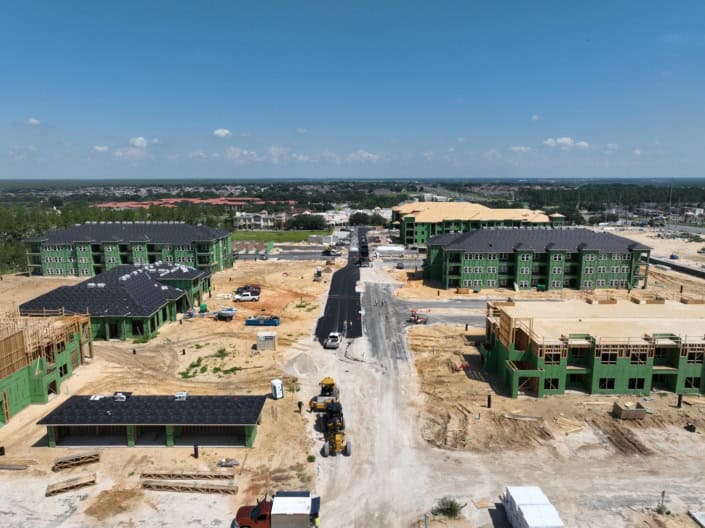 New residential apartment complex under construction in Florida with multi-story buildings, site development, and paved roads for modern living communities.
