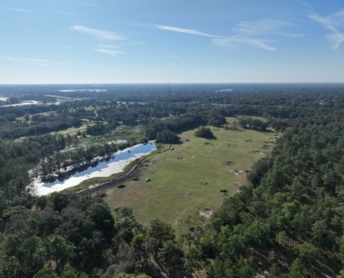 Spacious land for site development with water features and lush greenery, ideal for commercial or residential projects with scenic views and natural surroundings.