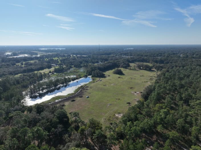 Spacious land for site development with water features and lush greenery, ideal for commercial or residential projects with scenic views and natural surroundings.