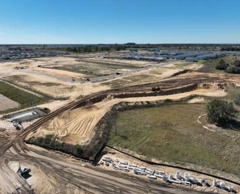 Excavation and site development for new residential community with heavy machinery and early construction stages.