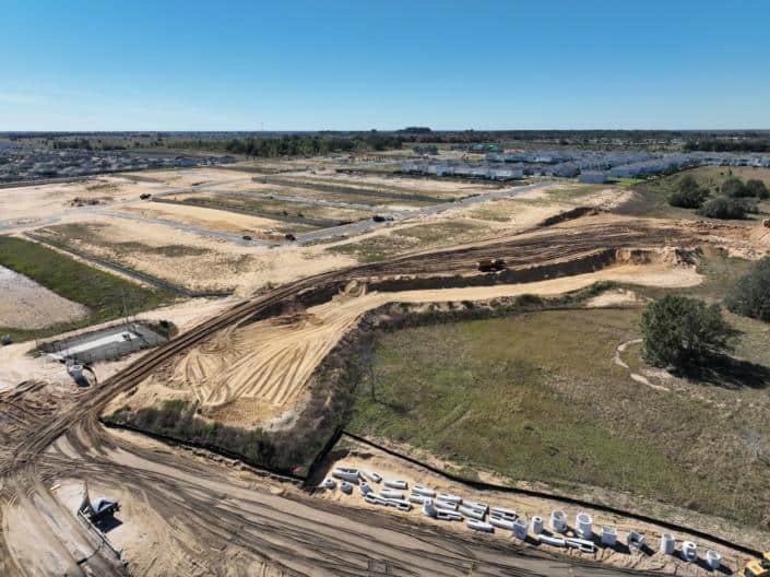 Excavation and site development for new residential community with heavy machinery and early construction stages.