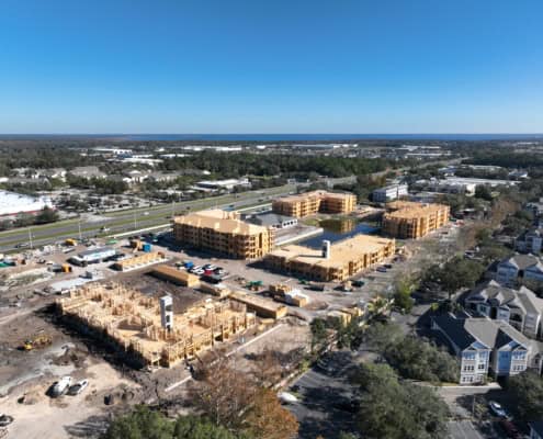 Modern residential construction site with multiple buildings under development and surrounding landscape, showcasing expertise in site development, residential construction, and urban planning.