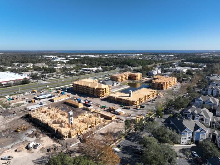 Modern residential construction site with multiple buildings under development and surrounding landscape, showcasing expertise in site development, residential construction, and urban planning.