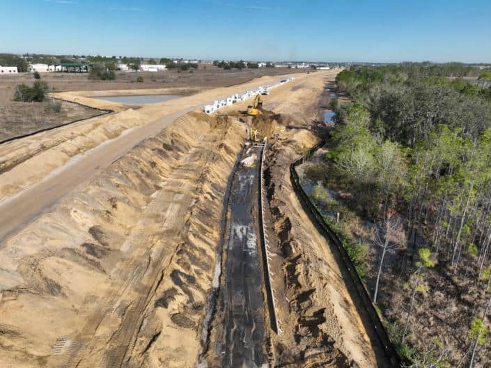 Modern construction site with earthworks and heavy machinery for site development and infrastructure planning.