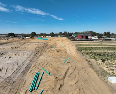 Installation of underground pipes on a construction site for site development and infrastructure.