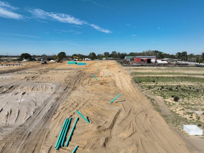 Installation of underground pipes on a construction site for site development and infrastructure.