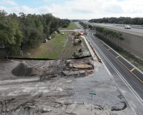 Construction site for highway and road development with ongoing earthwork and paving activities, showcasing infrastructure improvement and site preparation services.