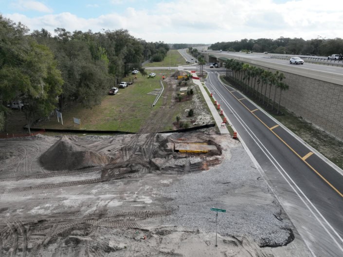 Construction site for highway and road development with ongoing earthwork and paving activities, showcasing infrastructure improvement and site preparation services.