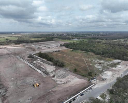Empty land construction site for commercial development with ongoing site preparation and grading.