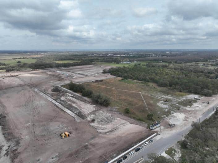 Empty land construction site for commercial development with ongoing site preparation and grading.