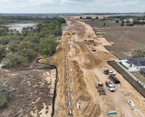 Earth-moving construction site for residential development, showcasing site clearing, excavation, and infrastructure installation in progress.
