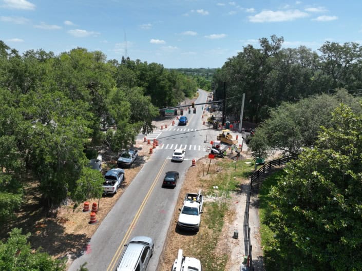 Roadway construction site with traffic and utility workers, highlighting infrastructure development and road improvement services for SEO.
