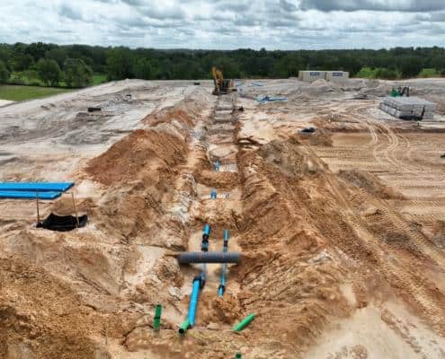 Underground utility installation on commercial construction site for site development and infrastructure.
