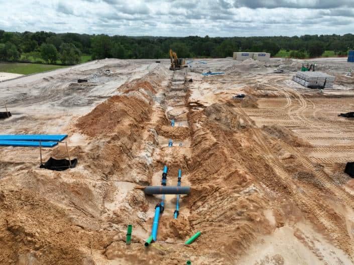 Underground utility installation on commercial construction site for site development and infrastructure.