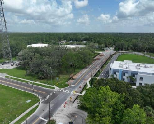 Construction site for commercial property development with roadwork and infrastructure in progress, focusing on site development, urban planning, and new building construction.