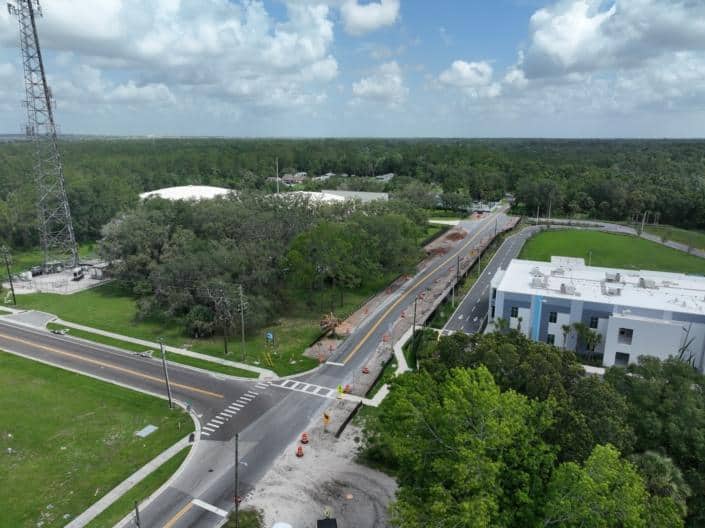 Construction site for commercial property development with roadwork and infrastructure in progress, focusing on site development, urban planning, and new building construction.