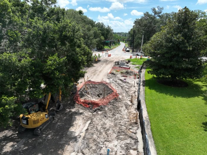 Excavation and road construction work underway for site development in Florida.
