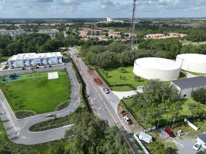 Modern commercial site development with underground utilities and landscaping, featuring water tanks, recreation areas, and accessible parking for optimized urban infrastructure.