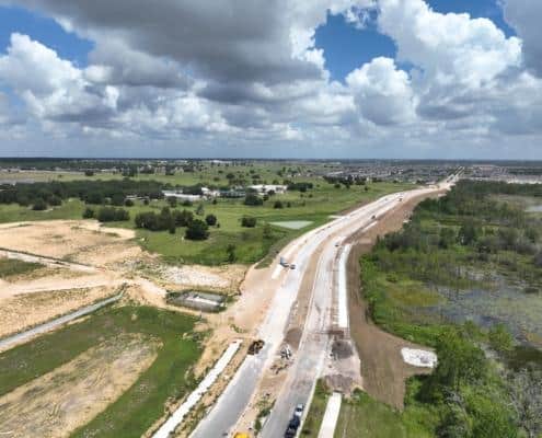Newly constructed road infrastructure with ongoing development and construction work, showcasing site development services and land preparation for commercial or industrial projects.