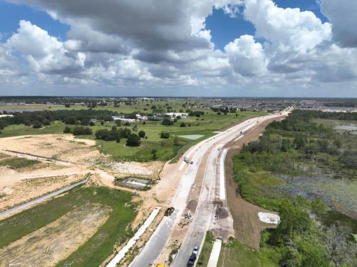 Newly constructed road infrastructure with ongoing development and construction work, showcasing site development services and land preparation for commercial or industrial projects.