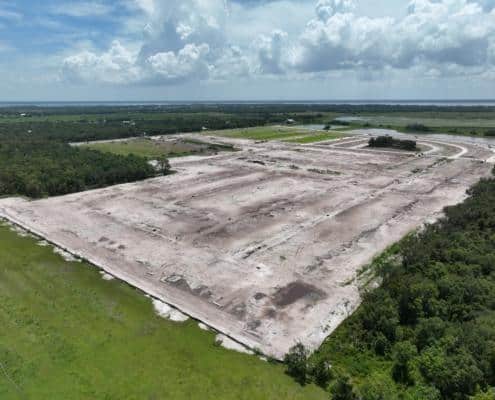 Large construction site development in progress with extensive land clearing and grading for new commercial or industrial project.