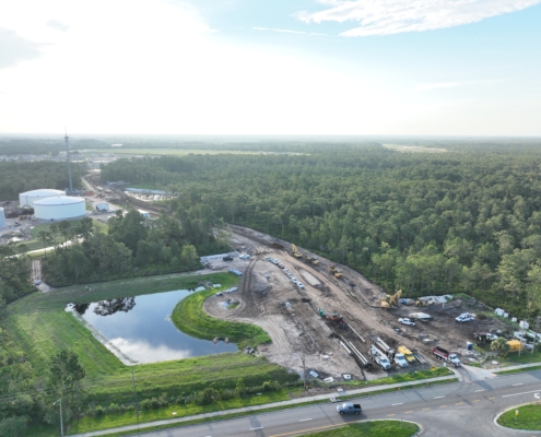Construction site with heavy machinery and cleared land for site development at SDC.