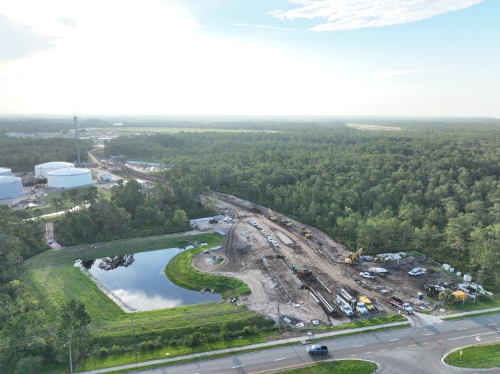 Construction site with heavy machinery and cleared land for site development at SDC.
