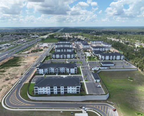 Modern multi-family apartment complex developed by SDC Site Development, showcasing efficient land use and infrastructure planning, with extensive parking and landscaped areas.