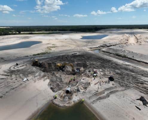 Heavy construction site with machinery, dirt work, and excavation in progress for land development and site preparation.
