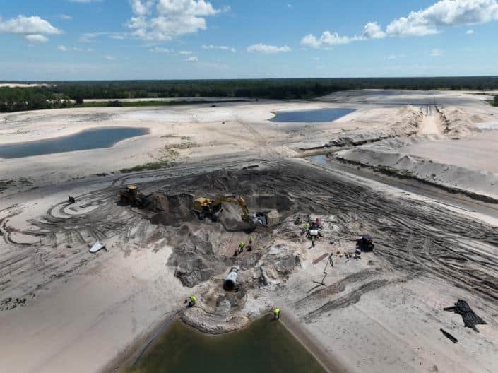 Heavy construction site with machinery, dirt work, and excavation in progress for land development and site preparation.