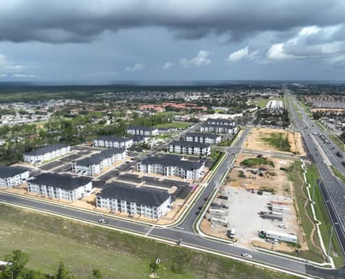 Modern residential development with new apartment buildings and infrastructure improvements, showcasing site development and urban planning.