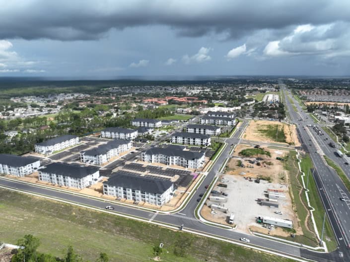 Modern residential development with new apartment buildings and infrastructure improvements, showcasing site development and urban planning.