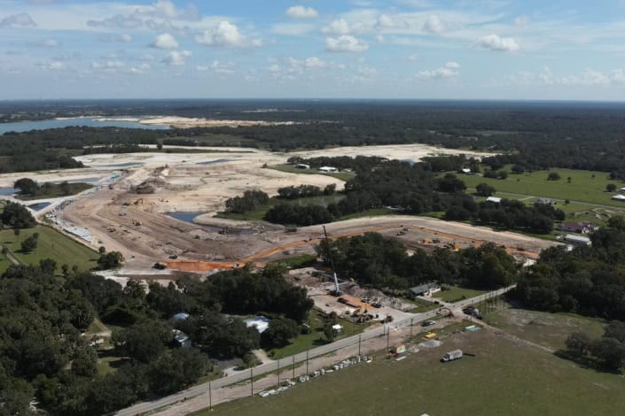 Aerial view of site development in Florida showcasing construction, earthmoving equipment, and land excavation for new infrastructure.