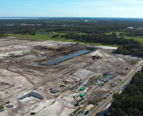 Modern site development and construction project in Florida, showcasing land clearing, excavation, and infrastructure setup for industrial or commercial development.