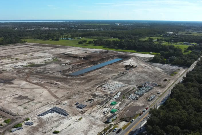 Modern site development and construction project in Florida, showcasing land clearing, excavation, and infrastructure setup for industrial or commercial development.
