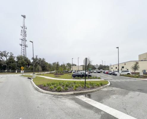 Modern office park parking lot with landscaped islands and a surrounding commercial building, emphasizing professional site development and outdoor space design for business environments.
