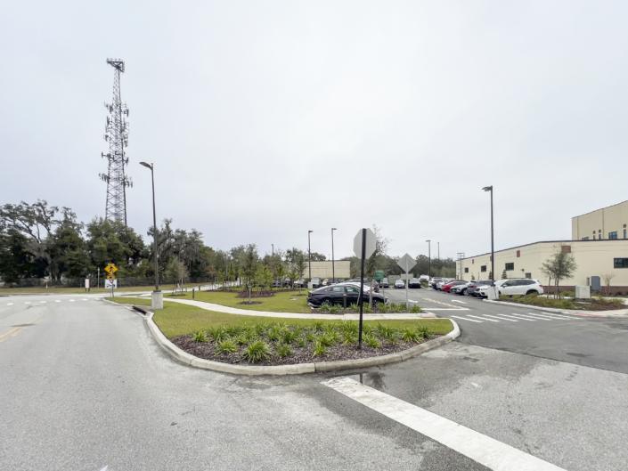 Modern office park parking lot with landscaped islands and a surrounding commercial building, emphasizing professional site development and outdoor space design for business environments.