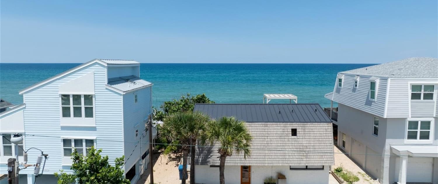 Oceanfront beach house with modern design, coastal architecture, and scenic views for beachfront property development and vacation rentals.
