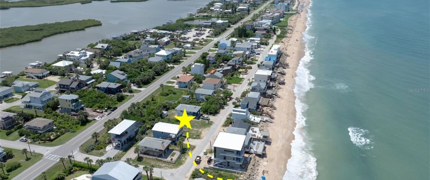 Oceanfront residential neighborhood with new beach houses and waterfront views, showcasing professional site development and coastal infrastructure, ideal for real estate or property development.