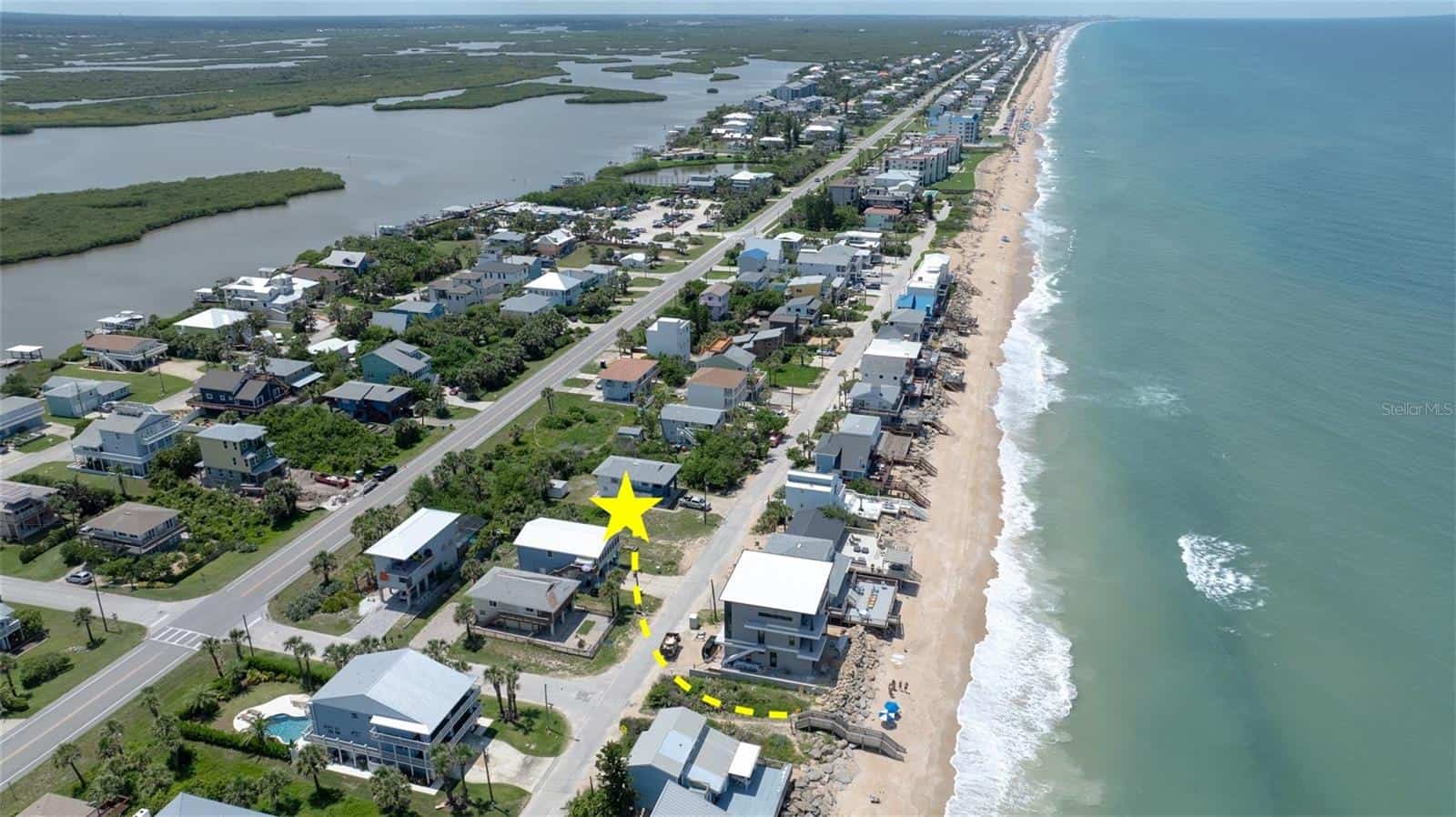 Oceanfront residential neighborhood with new beach houses and waterfront views, showcasing professional site development and coastal infrastructure, ideal for real estate or property development.