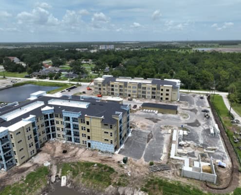 Modern apartment complex under construction demonstrating site development and building process.