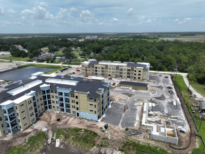 Modern apartment complex under construction demonstrating site development and building process.